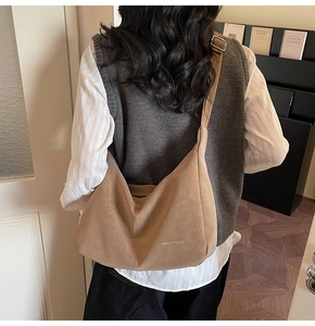 Detailed back view of a khaki large tote bag with textured faux leather and wide strap