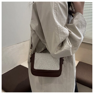Detail of vintage square crossbody bag featuring brown leather and white fleece texture