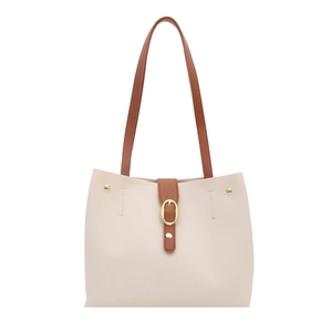 Minimalist cream tote bag with dark brown straps and golden hardware on white background