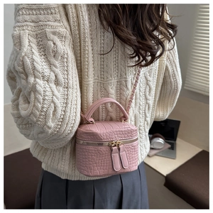 Mini borsa a tracolla rosa stampa coccodrillo abbinata a un maglione bianco