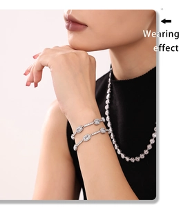 Close-up of silver steel bracelet with inlaid sparkling zircons on a model's wrist