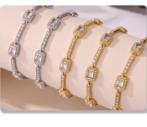 Detailed view of stacked gold and silver bracelets with inlaid cubic zirconia crystals