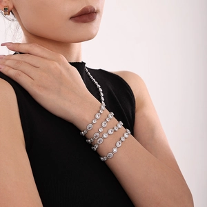 Handcrafted stainless steel bracelets with oval zircon stones on a model's wrist