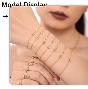Close-up of model wearing gold-plated initial letter jewelry set with pavé cubic zirconia