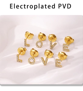 Macro view of gold PVD plated LOVE letter stud earrings with inlaid cubic zirconia