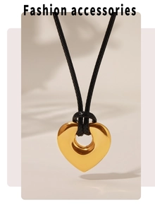 Détail d'un pendentif cœur doré poli avec cordon noir ajustable sur un fond doux et épuré