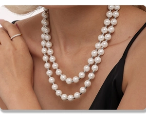 Detail of elegant double-layered 12mm shell pearl necklace with silver spacer beads