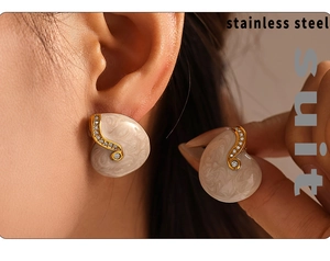 Detail of gold-plated stainless steel stud earring with cream marble inlay and zircon