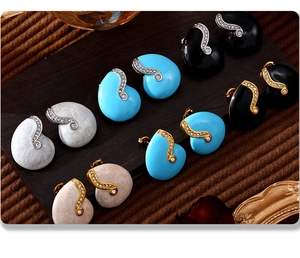 Detail of PVD gold plated earrings with colorful enamel glaze and zircon accents