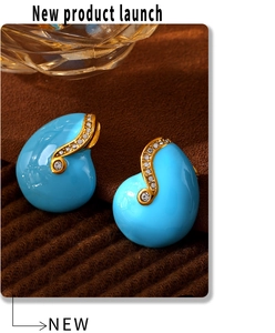 Macro detail of sky blue enamel drop earrings with gold plating and white zircon accents