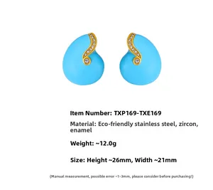 Detailed view of teardrop enamel earrings with gold wave pattern and white zircon stones