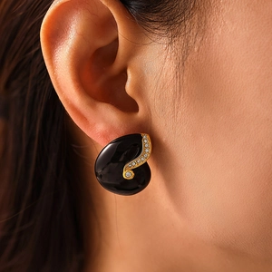 Elegant nautilus stud earrings in black enamel with gold plating and white zircon inlay