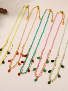 Detail of colorful faceted stone necklaces with water-drop pendants and S.Steel tags