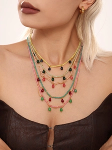 Detail of bohemian layered beaded necklace with colorful stones and teardrop pendants