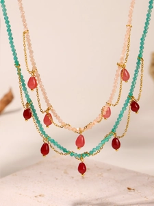 Detail view of Bohemian layered beaded necklace with teardrop opal charms and gold chains