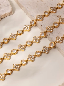 Detailed close-up of 18k gold plated flower bracelet with inlaid sparkling zircon stones