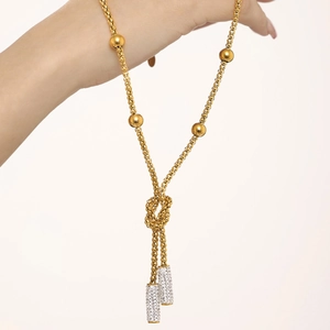 Gold-plated knot necklace with zircon sugar cube pendants and beads on a steel chain