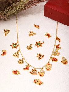 Macro view of Christmas necklace with colorful zircon Santa, reindeer and tree charms