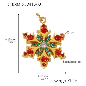 Detail of snowflake pendant with red, green and white zircons in gold stainless steel
