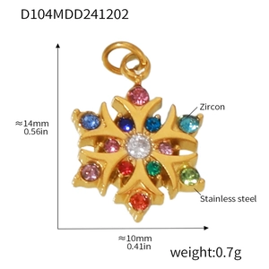 Macro detail of snowflake pendant in gold-plated steel with colorful zircons