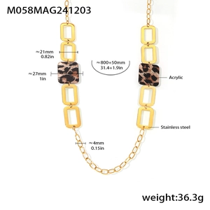 Macro detail of gold stainless steel necklace with leopard print acrylic square link