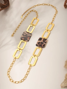 Detailed shot of leopard print acrylic squares and 18K gold-plated stainless steel chain