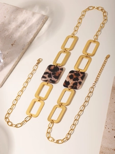 Detailed macro view of 18K gold plated stainless steel chain with leopard acrylic pieces