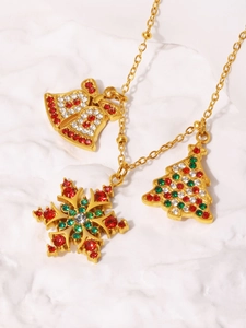 Detailed shot of Christmas necklace with bell, snowflake and tree charms in gold finish