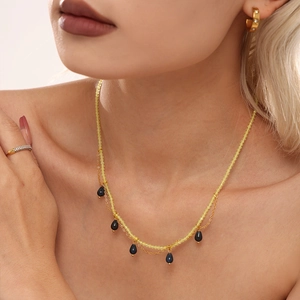 Double-layered beaded necklace with blue teardrop pendants and yellow natural stones