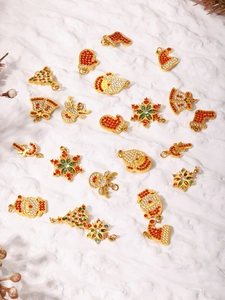 Macro shot of assorted Christmas steel pendants with colorful zircons on snow background