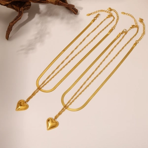 Detail of 18K gold plated double layer necklace with heart pendants and wavy chain