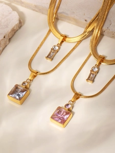 Close-up of double-layer gold stainless steel chain with square zircon pendants