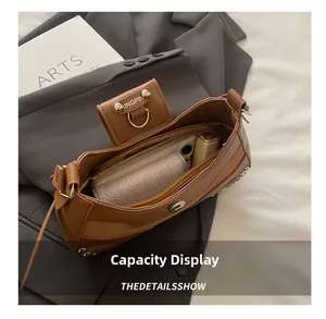Internal view of brown PU shoulder bag showing space for phone, wallet and lipstick
