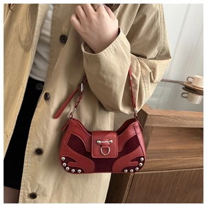 Detail of dark red rivet shell bag with leather and suede splicing and metal buckle