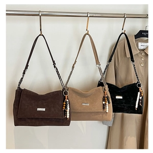 Detail of vintage crossbody bags with chain straps and beaded fringe charms