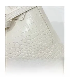 Close-up of premium white faux crocodile embossed texture on a large minimalist tote bag