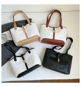 Flat lay of tote bags featuring woven texture, gold square buckles and contrast colors