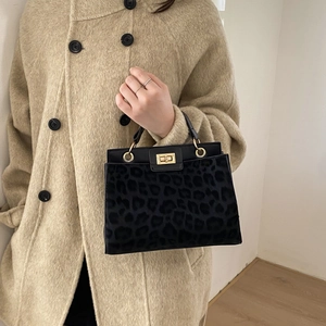 Retro black leopard print bucket bag with gold lock and sleek leather handle for women