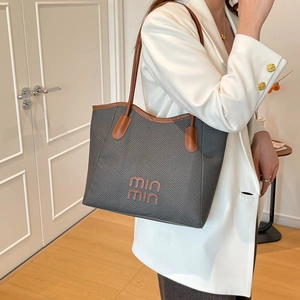 Retro grey large-capacity tote bag with brown leather straps shown in a stylish home setting
