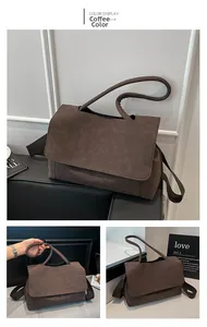 Detail view of coffee-colored faux suede tote bag with stylish wide shoulder strap