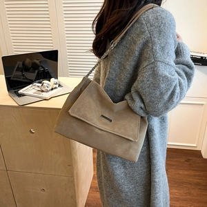 Khaki leather crossbody bag with metal chain strap and minimalist silver bar detail