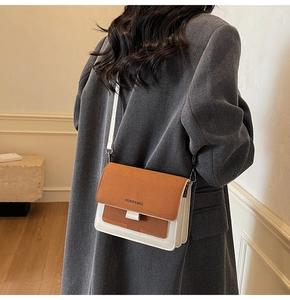 Detail of a minimalist square crossbody bag with tricolor patchwork and wide strap