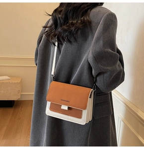 Detail of vintage matte crossbody bag with contrast stitching and adjustable wide strap