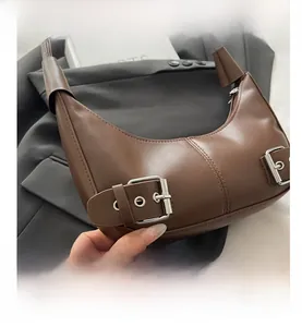 Detail shot of brown hobo bag featuring premium faux leather and silver metal buckles