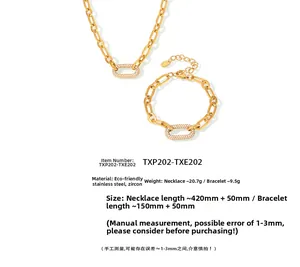 Détails macro d'un ensemble collier et bracelet trombone en acier doré avec zircons