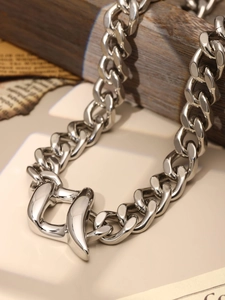 Close-up of polished silver heavy chain necklace with unique U-shaped chunky clasp
