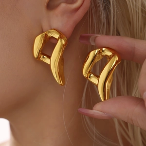 Polished gold irregular chunky earrings worn by model for elegant fashion style
