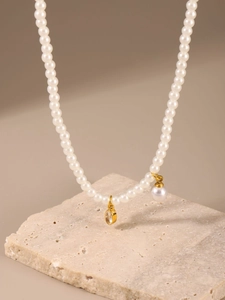Close-up of heart zircon and pearl pendants on a luxury beaded stainless steel choker