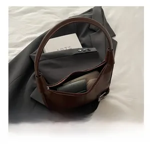 Internal view of the brown hobo bag showing capacity for phone, wallet and cosmetics