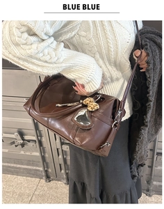 Detailed view of dark brown PU leather tote with silver heart buckle and leopard bow charm